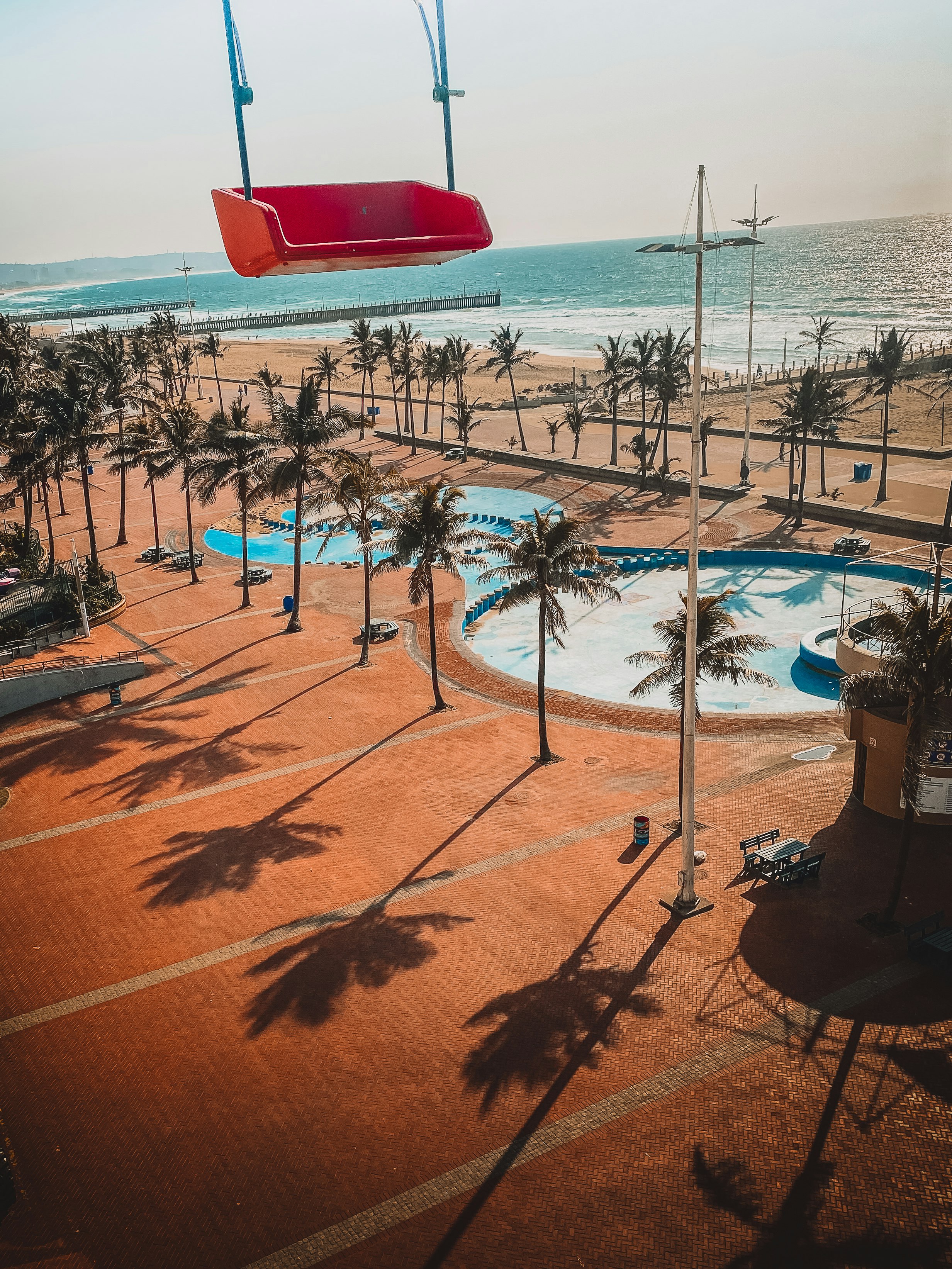 red and black outdoor chairs on beach during daytime